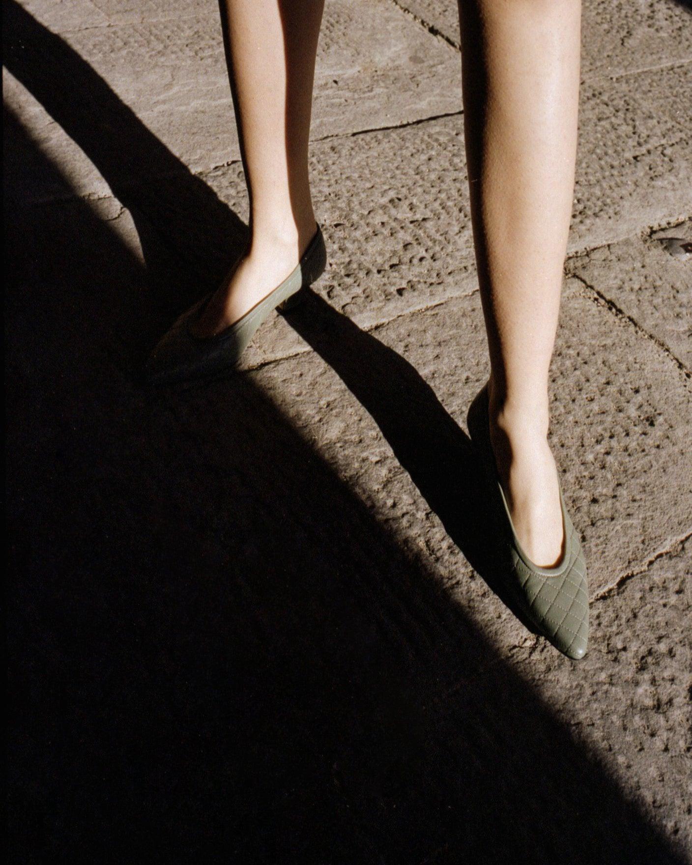 Close-up of feet wearing Pia Ballerina Flats in Sage Green