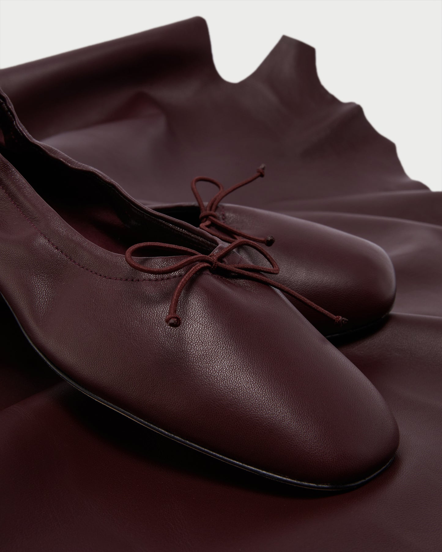 Close-up of Pia Ballerina Burgundy flats with bow detail