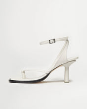 Load image into Gallery viewer, Side view of Yuni Buffa Castrise high Heel women strappy sandal in Cloud white. Artisanal crafted woman shoe made in Italy with Italian Lamb Nappa leather and silver logo buckle