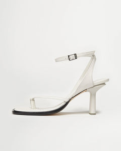 Side view of Yuni Buffa Castrise high Heel women strappy sandal in Cloud white. Artisanal crafted woman shoe made in Italy with Italian Lamb Nappa leather and silver logo buckle