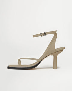 Side view of Yuni Buffa Castrise high Heel women strappy sandal in Sahara Beige. Artisanal crafted woman shoe made in Italy with Italian Lamb Nappa leather and silver logo buckle