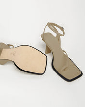 Load image into Gallery viewer, Leather Bottom view of Yuni Buffa Castrise strappy sandal high Heel in Sahara Beige color handmade in Italy with Italian Lamb Nappa leather and silver logo buckle