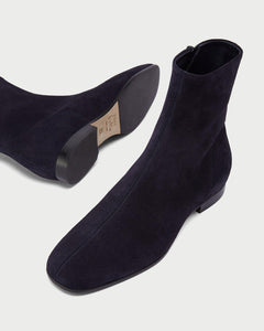 Perspective view of elegant Yuni Buffa Nightingale Suede Boot in Midnight Blue. Luxury  handcrafted clean lines and hugging fit designer squared toe boot in italian suede leather
