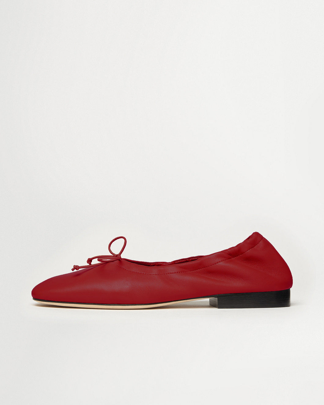 Side view of Yuni Buffa Pia Ballet flat designer shoes in Cherry Red. Luxury hand crafted square toe ballet flats made in Italy with Italian soft Lamb Nappa leather.