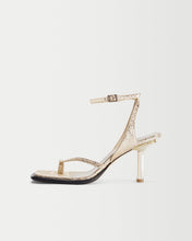 Load image into Gallery viewer, Side view of Yuni Buffa Castrise high Heel women strappy sandal in Comet Gold. Artisanal crafted woman shoe made in Italy with Italian Lamb Nappa leather and silver logo buckle.