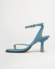 Load image into Gallery viewer, Side view of Yuni Buffa Castrise high Heel women strappy sandal in Bermuda blue. Artisanal crafted woman shoe made in Italy with Italian Lamb Nappa leather and silver logo buckle
