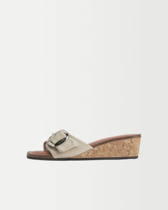 Side view of Yuni Buffa Lucca Sardinian cork wedge sandal shoe in Ecru white color with tan vachetta leather insole and crepe rubber outsole made in Italy with Italian Lamb Nappa leather