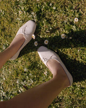Load image into Gallery viewer, On a sunny day in a Tuscan garden a model wearing Yuni Buffa Pia Ballerina shoe in Cloud white color made in Italy with Italian Lamb Nappa leather